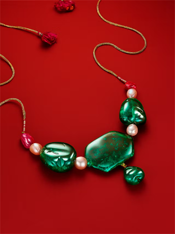 A multi-gemstone and emerald necklace.