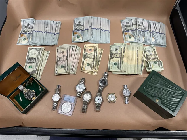 Watches and cash taken from the suspects.