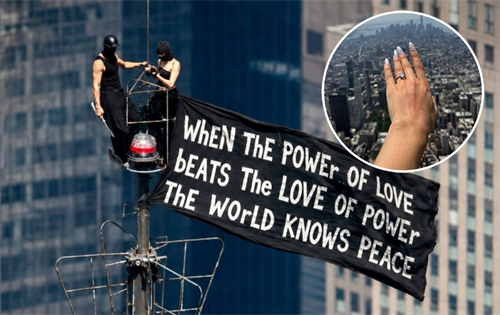 A Russian daredevil couple has climbed New York's Empire State Building and displayed a world peace banner as part of an elaborate marriage proposal that ended with their arrest. | Source: IMJUSTBAIT