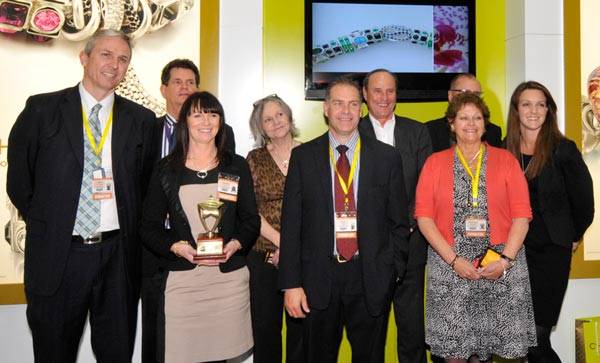 Chamilia team beaming with their best large stand award